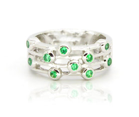 Sterling silver ring with green round gemstones in stacked row setting