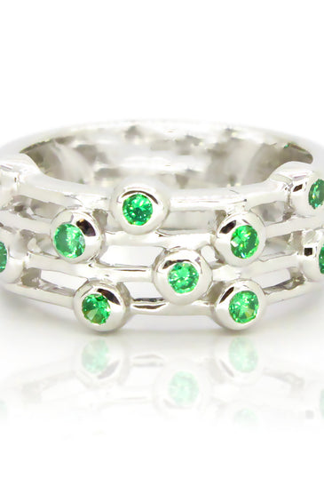 Whimsical sterling silver ring featuring green topaz with a bezel design