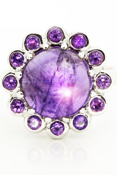 Sterling silver ring with round amethyst cabochon and purple halo stones