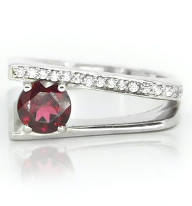 Sterling silver ring showcasing round garnet and white topaz