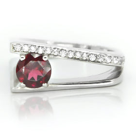 Sterling silver ring showcasing round garnet and white topaz