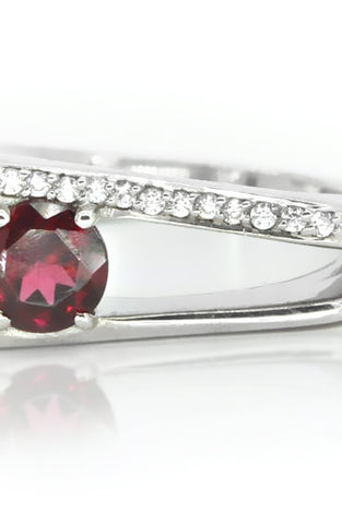 Sterling silver ring showcasing round garnet and white topaz