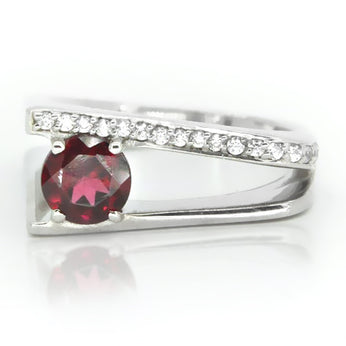 Sterling silver ring showcasing round garnet and white topaz