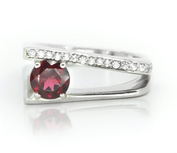 Sterling silver ring showcasing round garnet and white topaz