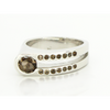 Sterling silver ring with smoky quartz centerpiece and rows of dark and clear stones